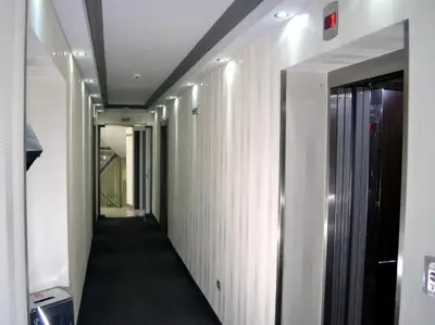 a corridor of an office building with a hallway at Elate Plaza Hotel in Sofia
