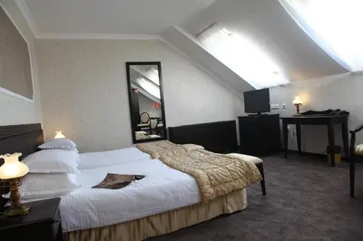 a hotel room with a large bed and a mirror at Strimon Garden Medical SPA Hotel in Kyustendil