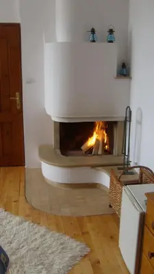 a fireplace in a living room with a fire in it at Rahoff hotel in Bansko
