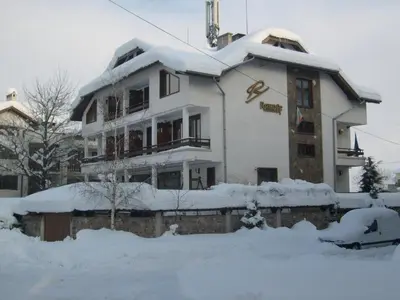 a building covered in snow in front at Rahoff hotel in Bansko