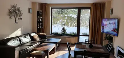 a living room with a couch and a table at TERRA COMPLEX D4 - Private apartment - Golf, Skiing & SPA in Bansko