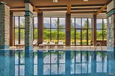 a swimming pool with lounge chairs and a large building at TERRA COMPLEX D4 - Private apartment - Golf, Skiing & SPA in Bansko