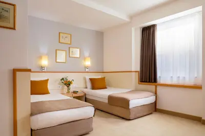 a hotel room with two beds and a window at Arte Sofia Hotel in Sofia