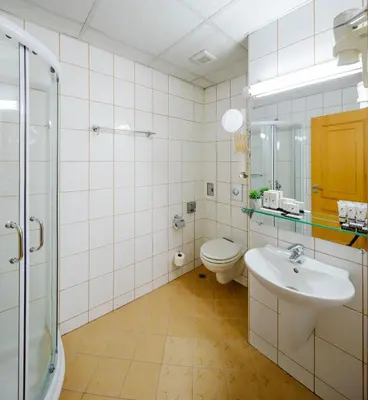 a bathroom with a toilet and a sink and a shower at Arte Sofia Hotel in Sofia