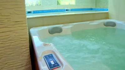 a jacuzzi tub with a thermometer in it at Hotel Rila in Dupnitsa