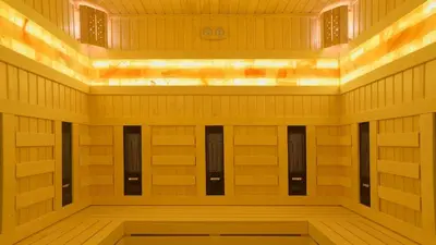 a sauna with wooden walls and a row of lockers at Hotel Rila in Dupnitsa