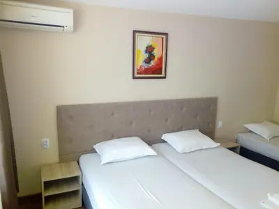two twin beds in a bedroom with a picture on the wall at Panorama Hotel in Sandanski