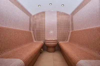 a small bathroom with two benches and a shower at Mountain Paradise next to Sunrise in Bansko