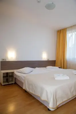 a bedroom with two beds and a window at Mountain Paradise next to Sunrise in Bansko