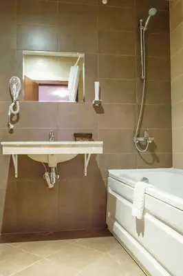 a bathroom with a sink and a bath tub at Mountain Paradise next to Sunrise in Bansko