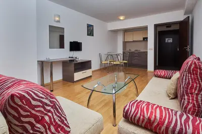 a living room with a couch and a glass table at Mountain Paradise next to Sunrise in Bansko