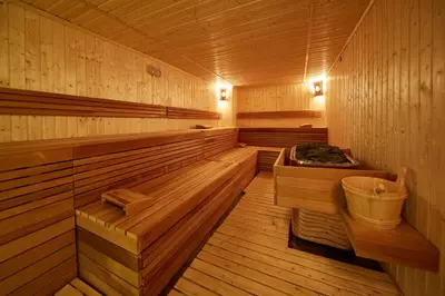 a sauna with a tub in the middle of it at Grand Hotel Velingrad in Velingrad