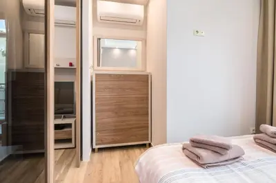 a small bedroom with a bed and a mirror at M&M Modern & Multifunctional One Bedroom Apartment by Flat Mаnager in Sofia