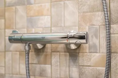 a shower head on a wall with a hose at M&M Modern & Multifunctional One Bedroom Apartment by Flat Mаnager in Sofia