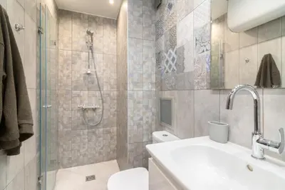 a bathroom with a shower and a toilet and a sink at M&M Modern & Multifunctional One Bedroom Apartment by Flat Mаnager in Sofia