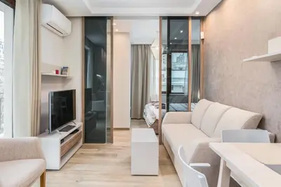 a living room with a couch and a tv at M&M Modern & Multifunctional One Bedroom Apartment by Flat Mаnager in Sofia