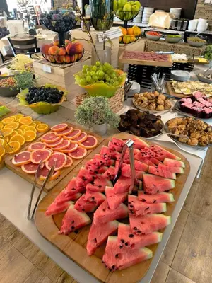 a buffet of fruits and vegetables on a table at Hotel Bansko SPA & Holidays - Free Parking in Bansko