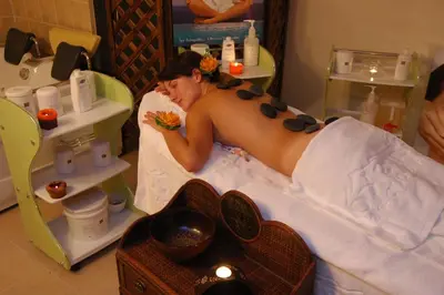 a man laying in a bath tub eating food at Hotel Bansko SPA & Holidays - Free Parking in Bansko