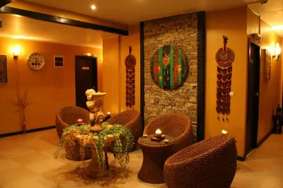 a lobby with wicker chairs and a table with candles at Hotel Bansko SPA & Holidays - Free Parking in Bansko