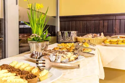 a buffet with desserts and other food on a table at The Stream Resort Pamporovo in Pamporovo