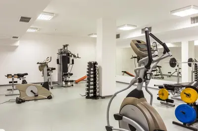 a gym with several treadmills and exercise equipment at The Stream Resort Pamporovo in Pamporovo