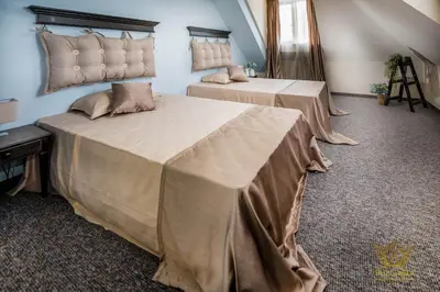 two beds sitting in a room with at Wellness Hotel Bulgaria in Bansko