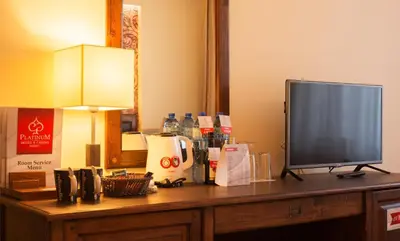 a television sitting on top of a desk in a room at Platinum Hotel and Casino Bansko in Bansko