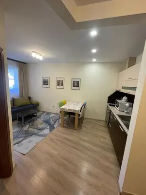 a small living room with a table and a couch at Royal Plaza Apartments Borovets in Borovets