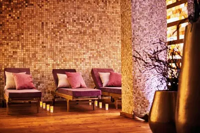 a row of chairs with pillows in a room at Lucky Bansko Aparthotel SPA & Relax in Bansko