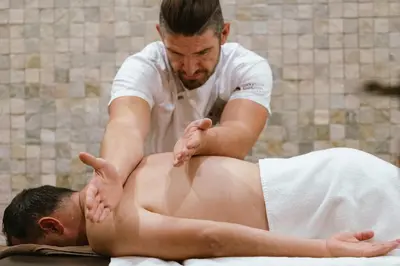 a man receiving a massage from a man in a towel at Lucky Bansko Aparthotel SPA & Relax in Bansko