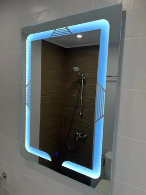 a blue lighted mirror in a bathroom with a shower at Horizont Dobrinishte in Dobrinishte