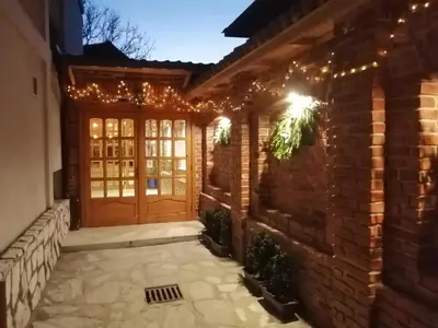 a front door of a house with christmas lights at Horizont Dobrinishte in Dobrinishte