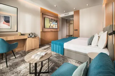 a hotel room with a bed and a couch at Park & Spa Hotel Markovo in Plovdiv
