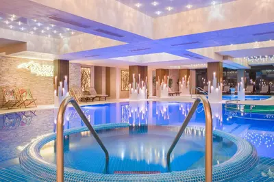a large swimming pool in a hotel lobby with a large pool at Park & Spa Hotel Markovo in Plovdiv