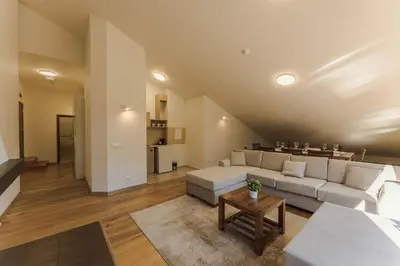 a living room with a couch and a table at Musala Hotel in Borovets