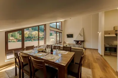a large dining room with a table and chairs at Musala Hotel in Borovets