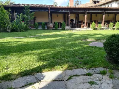 a yard in front of a house with green grass at Once upon a time in Koprivshtitsa
