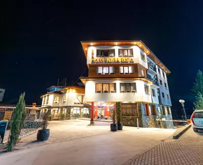 a hotel building with a sign on the front of it at SPA Hotel Kiparis in Smolyan