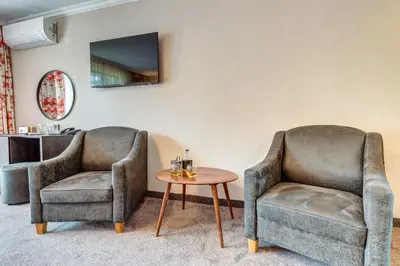 two chairs and a table in a room at SPA Hotel Kiparis in Smolyan
