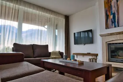 a living room with a couch and a table at Local Stay Hotel, BW Signature Collection in Bansko