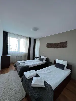 a hotel room with three beds and a window at Local Stay Hotel, BW Signature Collection in Bansko