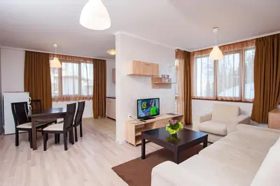 a living room with a couch and a table at Forest Nook Aparthotel in Pamporovo