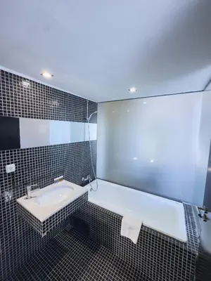 a bathroom with a sink and a mirror at Riverside Boutique Hotel in Bansko