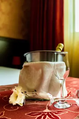 a wine glass sitting on top of a table at Hotel Montecito in Sofia
