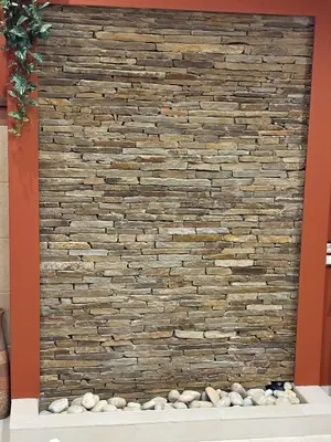a stone wall with rocks in front of it at Hotel Smilen in Smolyan