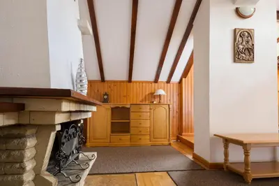a living room with a fireplace and a table at Victoria Hotel Borovets - Free Parking in Borovets