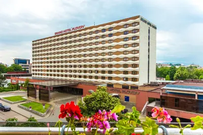 a hotel building with a sign on top of it at Grand Hotel Plovdiv in Plovdiv