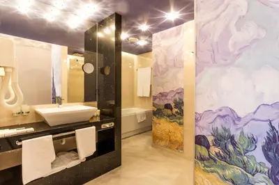 a bathroom with a sink and a mural at Grand Hotel Plovdiv in Plovdiv