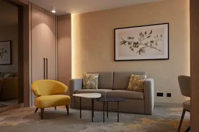 a living room with a couch and a chair at Hilton Sofia in Sofia