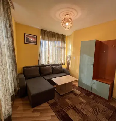 a living room with a couch and a table at ALPHA family HOTEL in Blagoevgrad